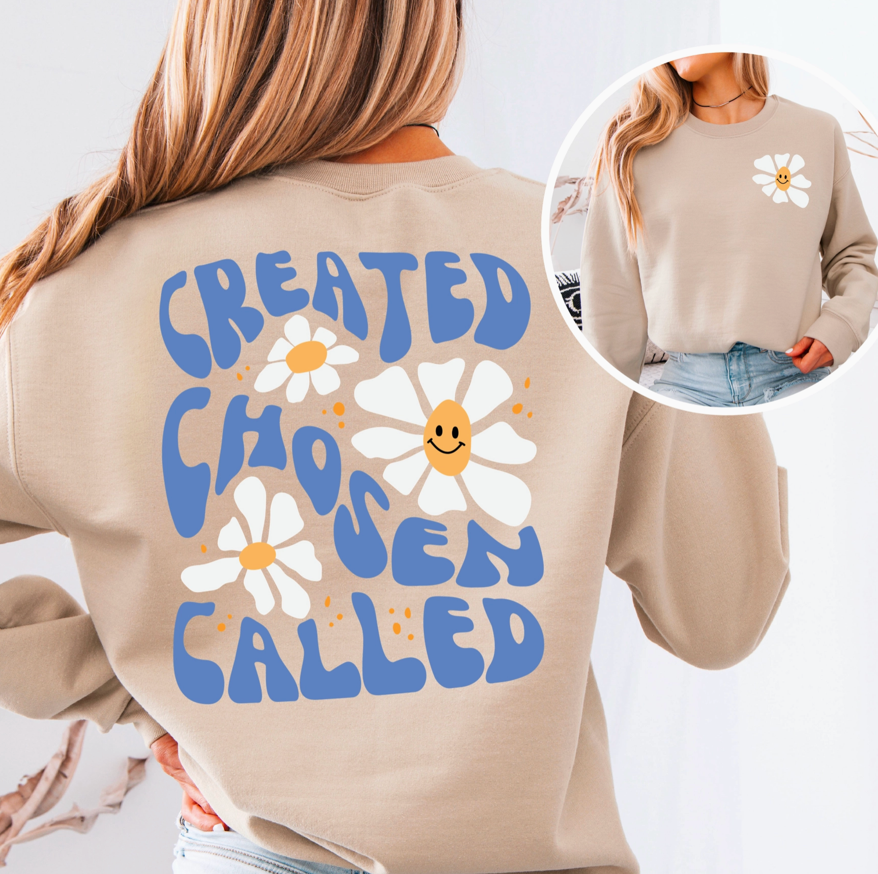 Beige sweatshirt with blue text and white flowers, worn by a person.