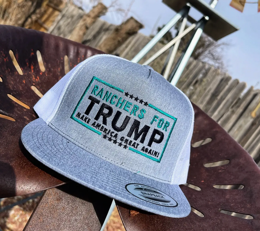 Gray cap with 'Ranchers for Trump' text on a wooden surface