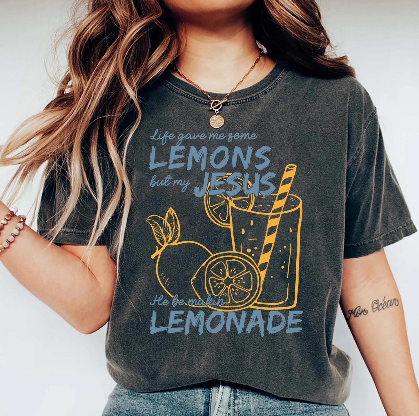 Person wearing a t-shirt with a graphic design and text.