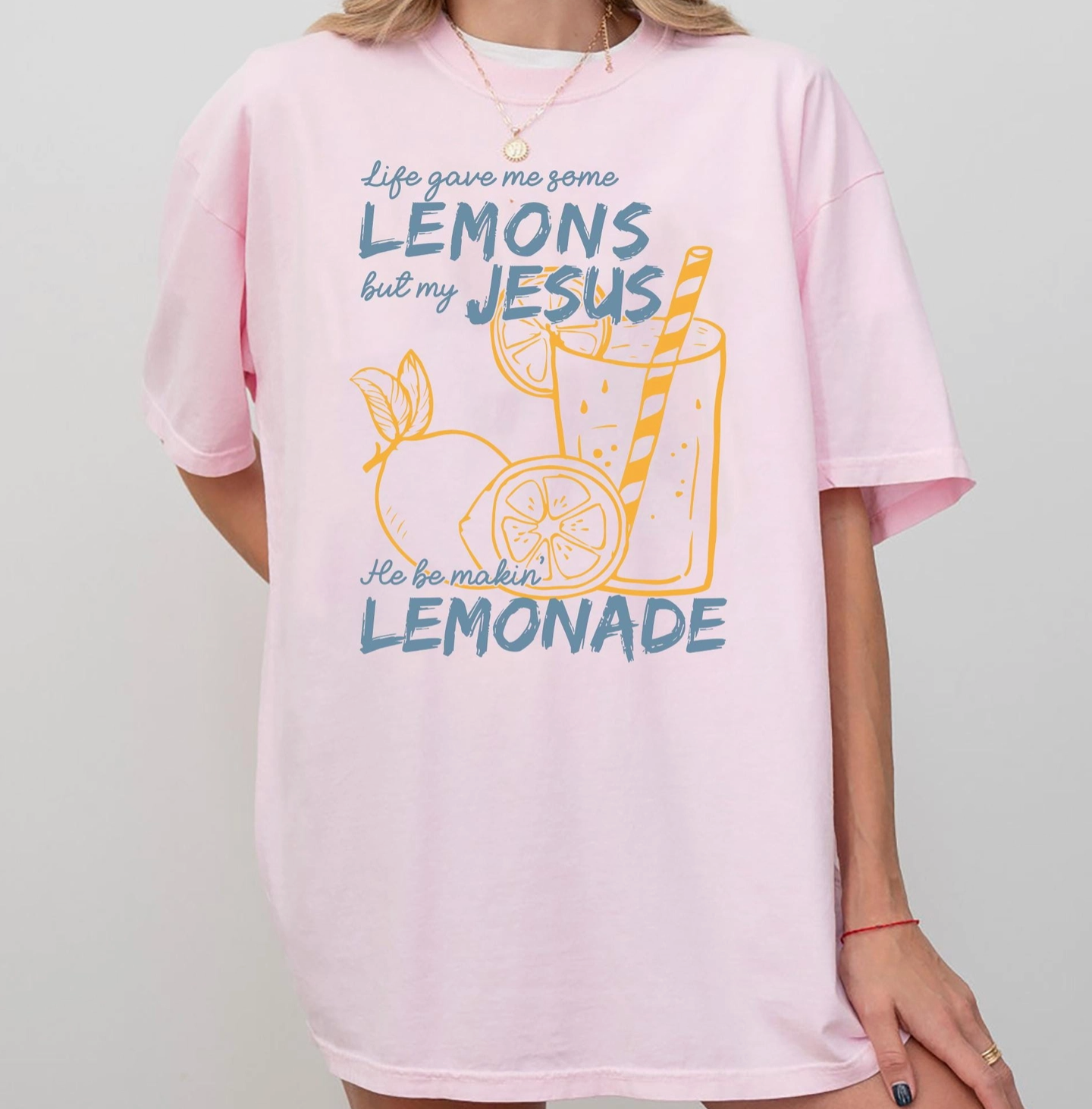 Pink t-shirt with lemon-themed graphic and text on a plain background